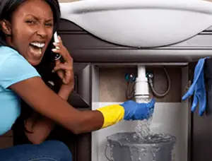 Emergency plumbing repair for a leaking sink drain under a bathroom vanity in Spokane, WA